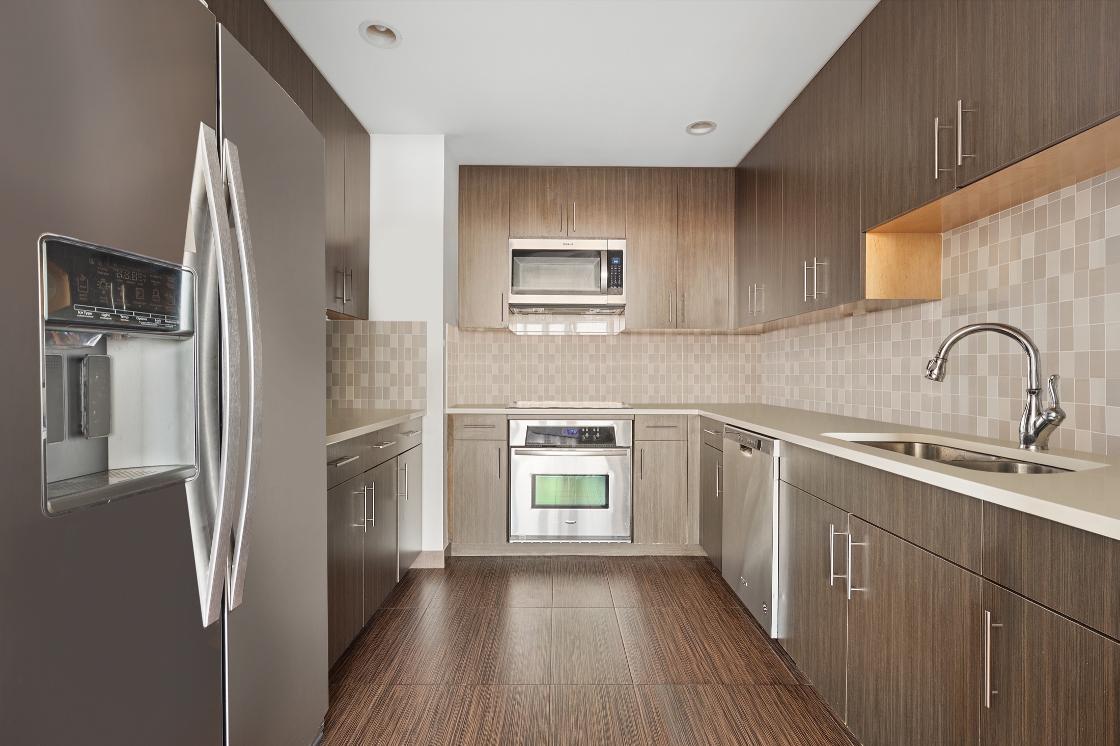 Full galley kitchen in Solarium Condominium residence 5C with extensive cabinetry